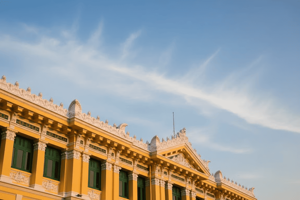 The exterior facade of the post office is a harmonious fusion of French design principles and Vietnamese cultural adaptations